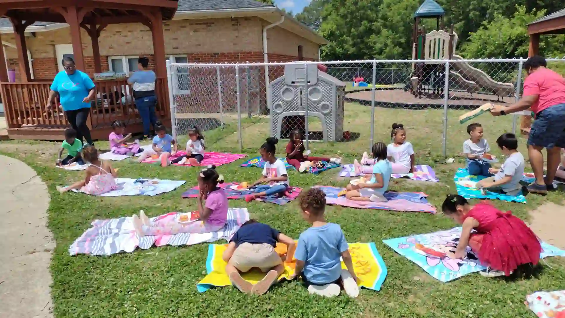 Kids sitting outside Primary beginnings